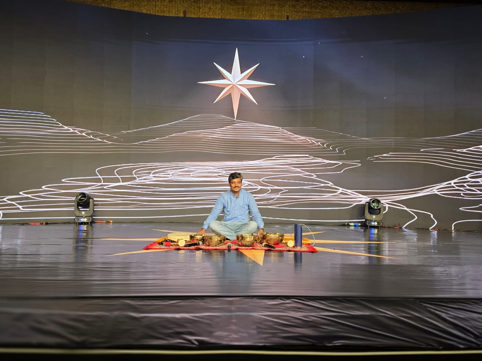 Prathyush leading a live sound healing session on stage